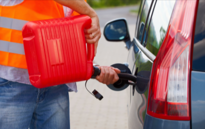 Fuel Delivery Salem IL roadside assistance by Ed Holsapple Towing filling car tank with fuel safely